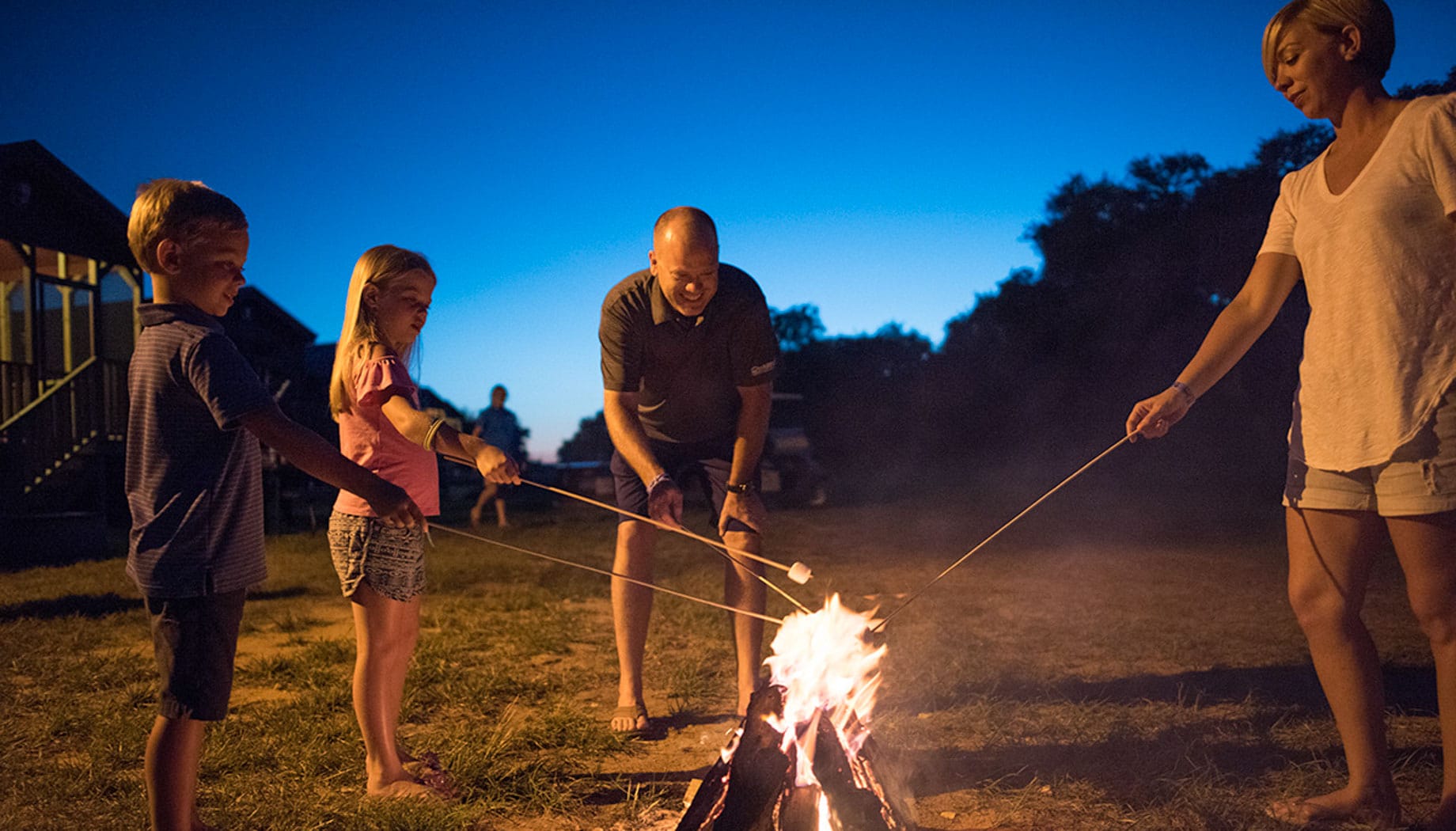 campfire Family toasting marshmallows around a campfire.
